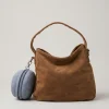 tenue de prière de voyage Unnie Djouher accroché avec un mousquetonà à un mini sac à main